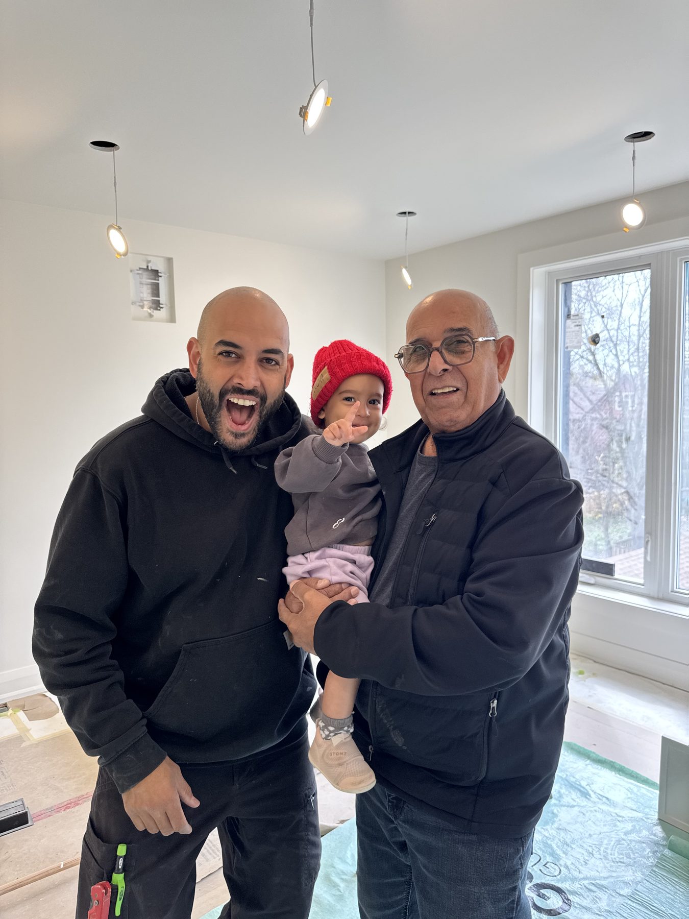 Three generations of the Yefet family together on a Toronto renovation site