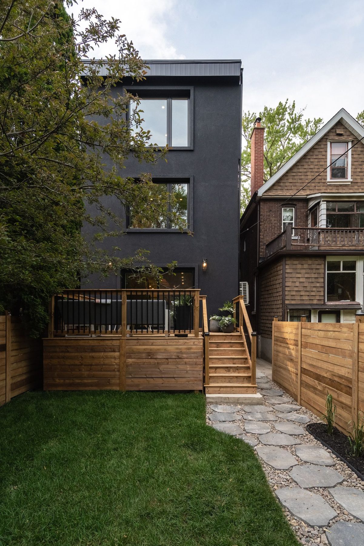 Contemporary rear addition integrated with a renovated Toronto brick home