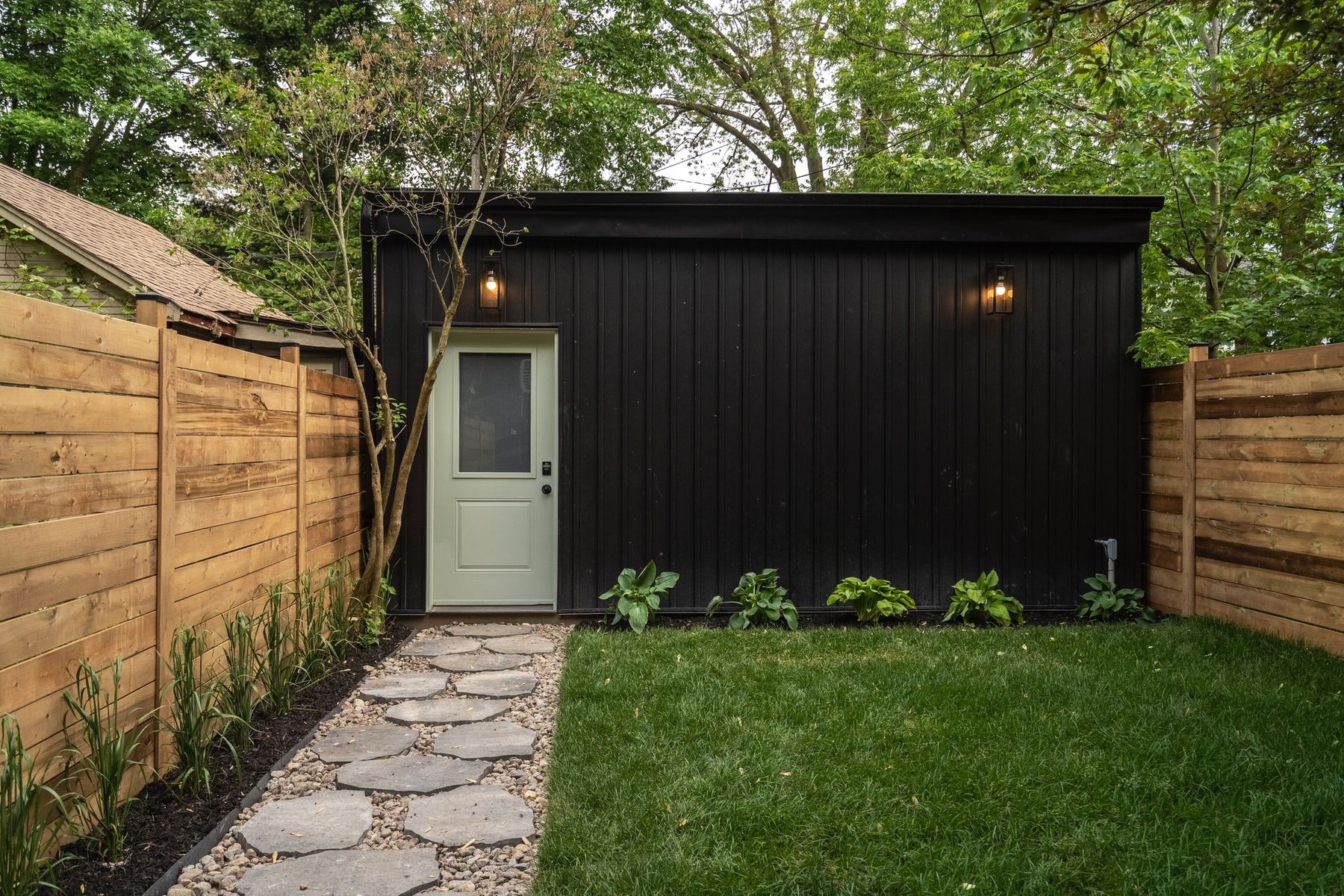 Landscaped Toronto backyard beside a completed rear home addition